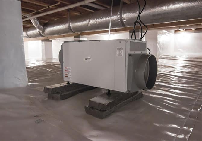 Dehumidifier in a home crawlspace after water damage restoration